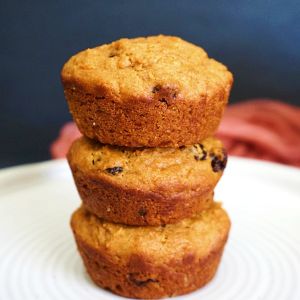 Stack of eggless carrot muffins on plate.