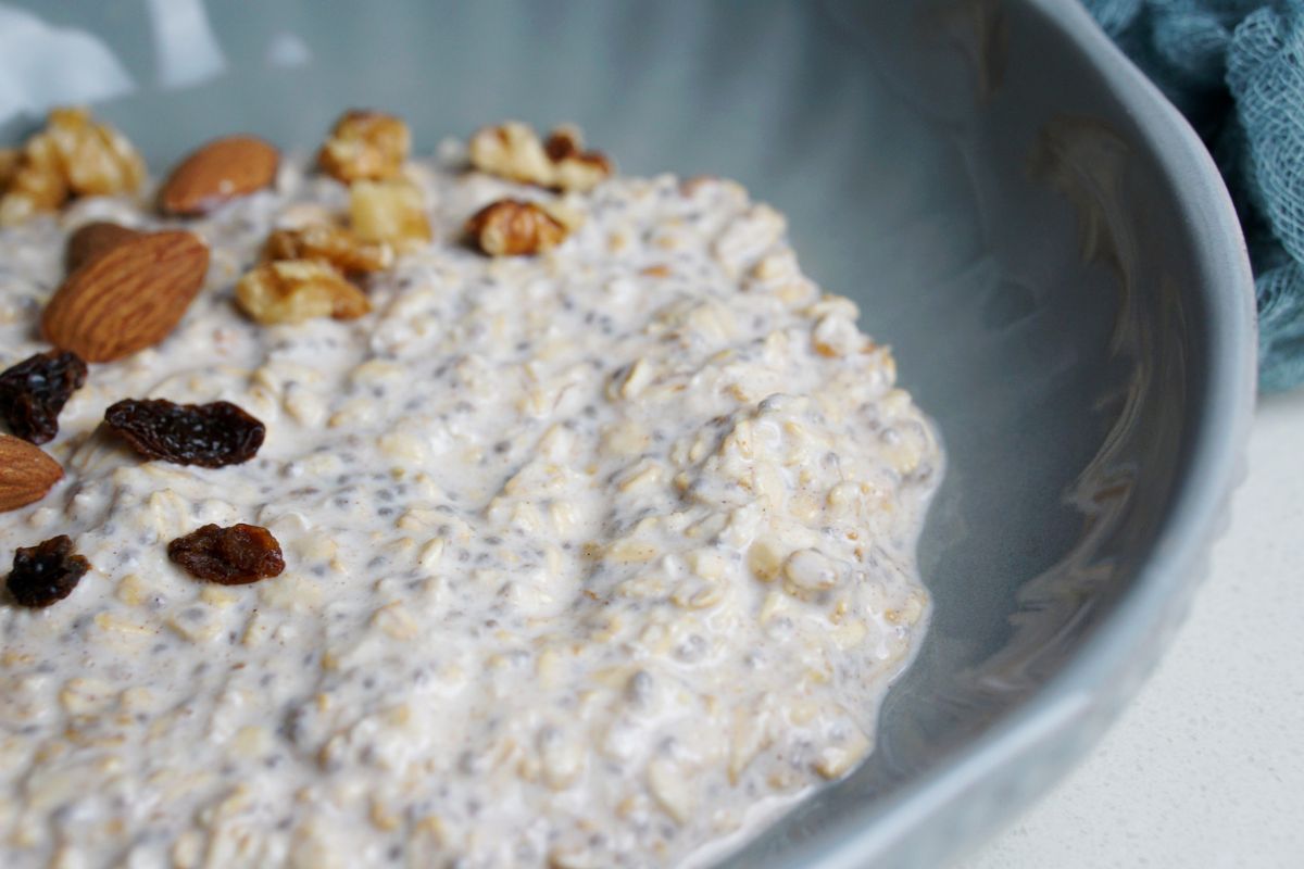 Overnight oats in a grey bowl with toppings.