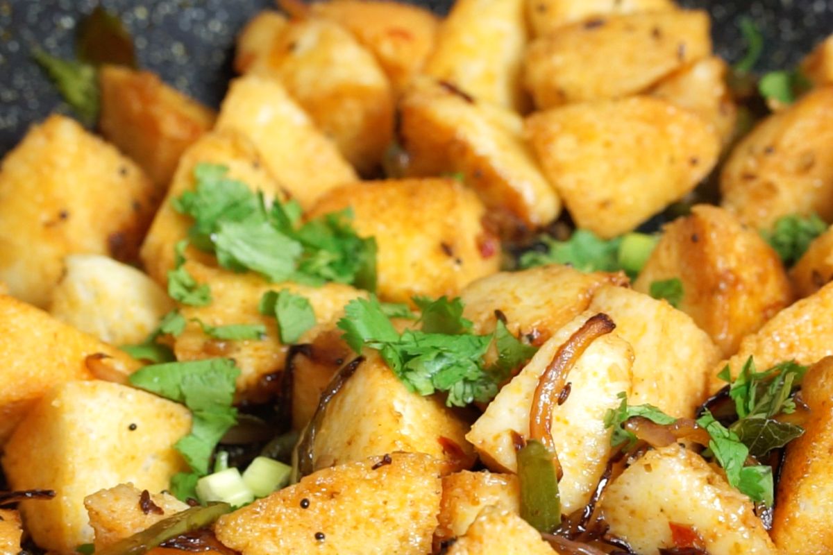 Garnished idli pieces in the pan.