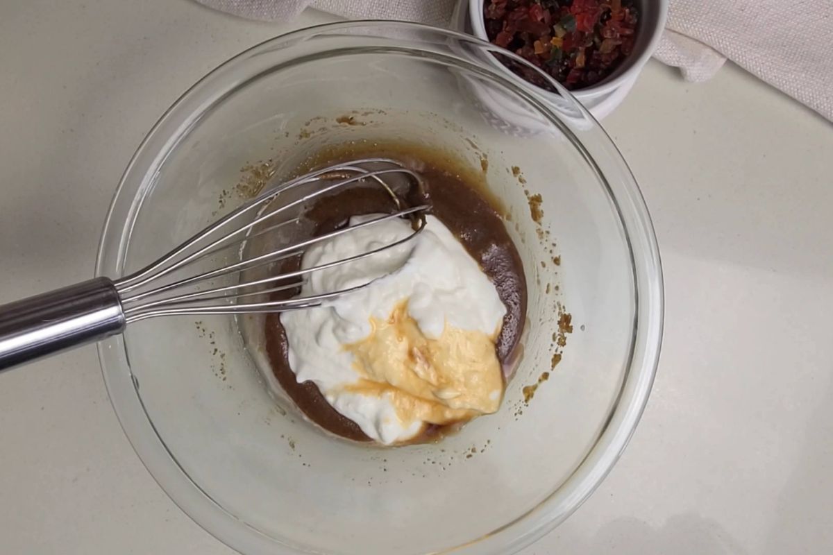 Yogurt and vanilla extract added to bowl.