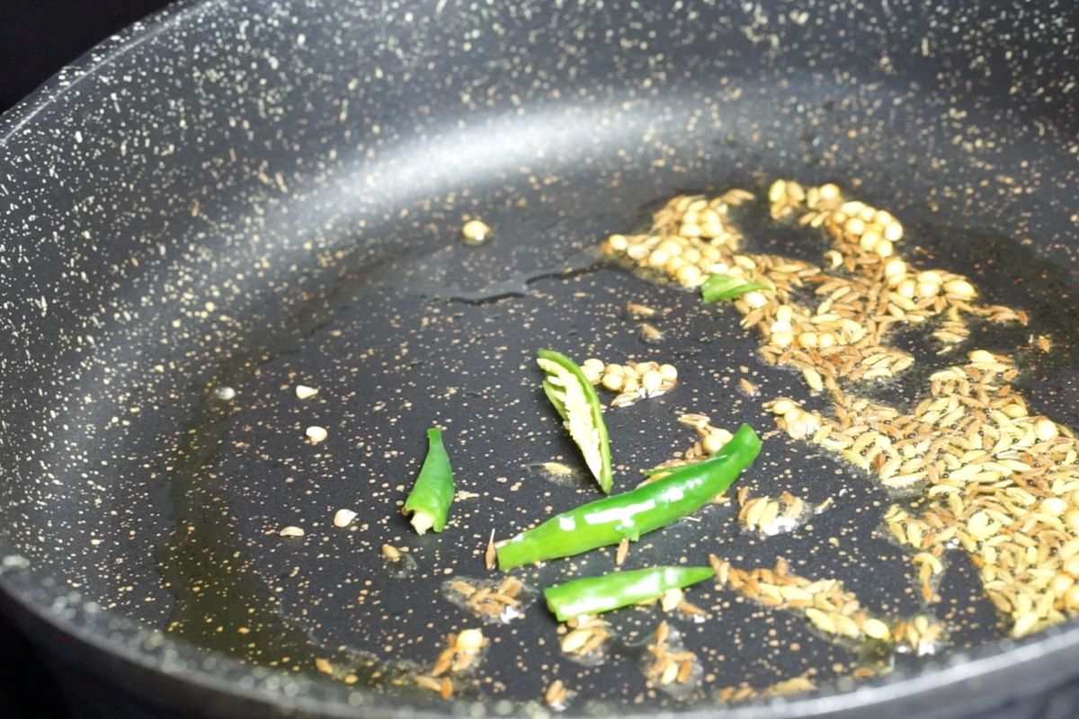Green chili added to the pan.