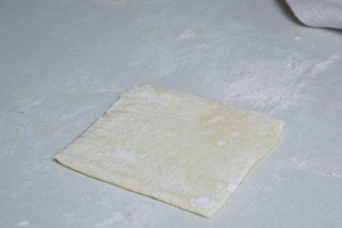 Pastry square rolled with rolling pin.