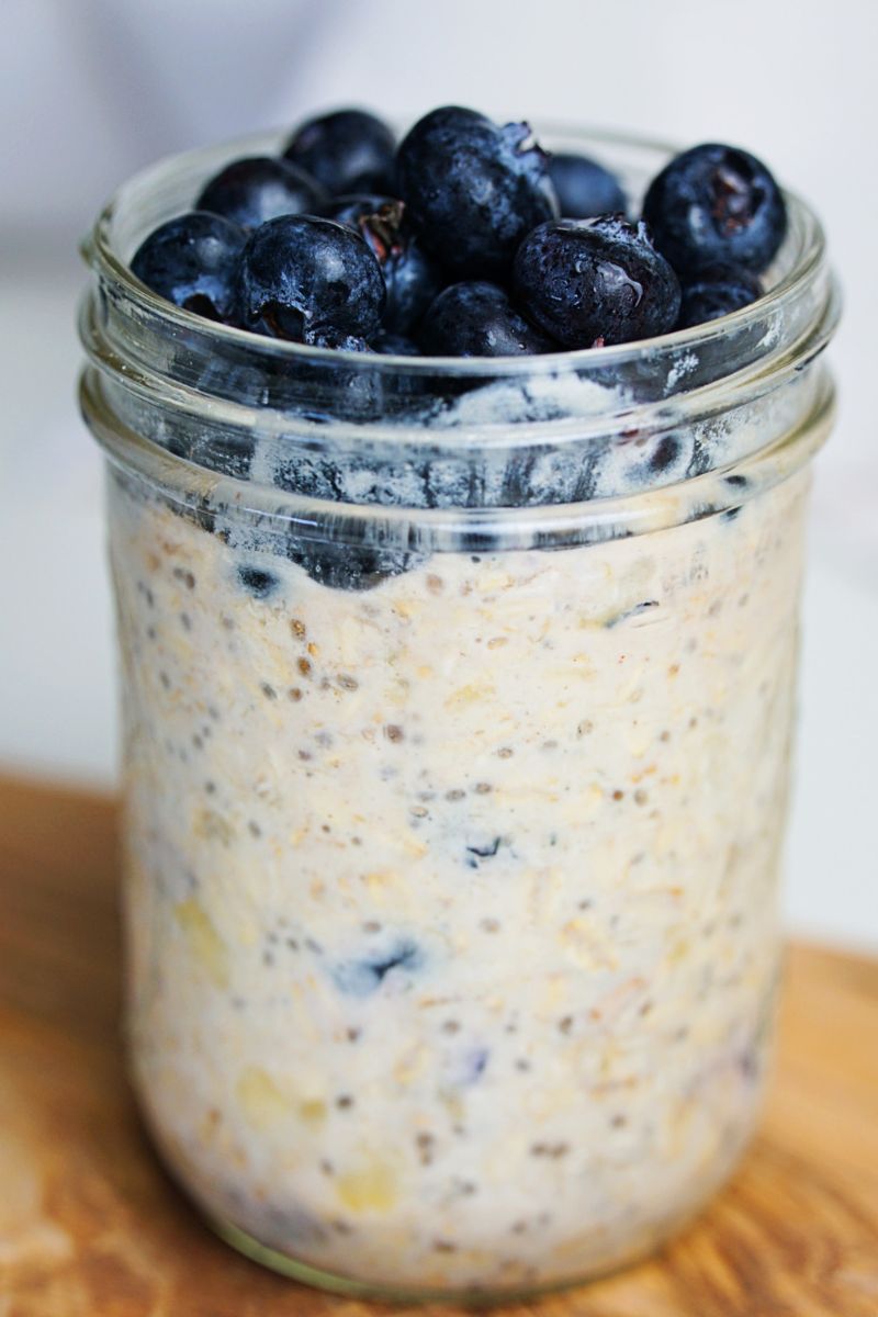 Banana overnight oats in a jar topped with blueberries.