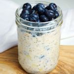 Banana overnight oats topped with blueberries in a jar.