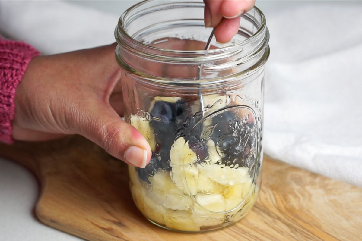 Chopped banana and blueberries mashed in the jar.